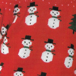 May include: Red knitted sweater with a white snowman pattern. The sweater is covered in snowmen with black hats and green scarves.