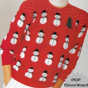 May include: Red knitted sweater with a pattern of white snowmen wearing black hats and green scarves. The sweater has a white dotted pattern on the shoulders and sleeves. The text "PDF Download" is visible in the lower right corner of the image.