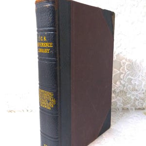 May include: An antique book with a dark blue leather spine and a brown cover. The spine features gold lettering that reads "I.C.S. REFERENCE LIBRARY" and "GEOMETRICAL ORNAMENTAL ARCHITECTURAL SHADE AND PERSPECTIVE DRAWING".