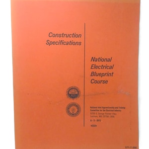 May include: An orange booklet titled "Construction Specifications" and "National Electrical Blueprint Course." The booklet includes the National Joint Apprenticeship and Training Committee for the Electrical Industry logo and address. The bottom right corner has the number 571-7-356.