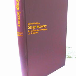 May include: A burgundy hardcover book titled "Stage Scenery: Its Construction and Rigging" by A.S. Gillette. The book is a second edition.