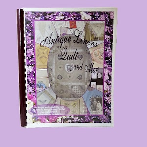 May include: A spiral-bound instructional book titled Antique Linens Quilt and More by Cindy Losekamp. The cover features a collage of embroidered fabric designs surrounded by a border of purple and white flowers on a white background.