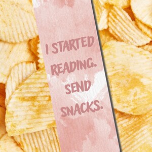 May include: A pink watercolor bookmark with the text "I STARTED READING. SEND SNACKS." is set against a background of ridged potato chips. The bookmark is rectangular with rounded corners.
