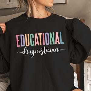 May include: Black sweatshirt with the text "EDUCATIONAL diagnostician" in rainbow colors.