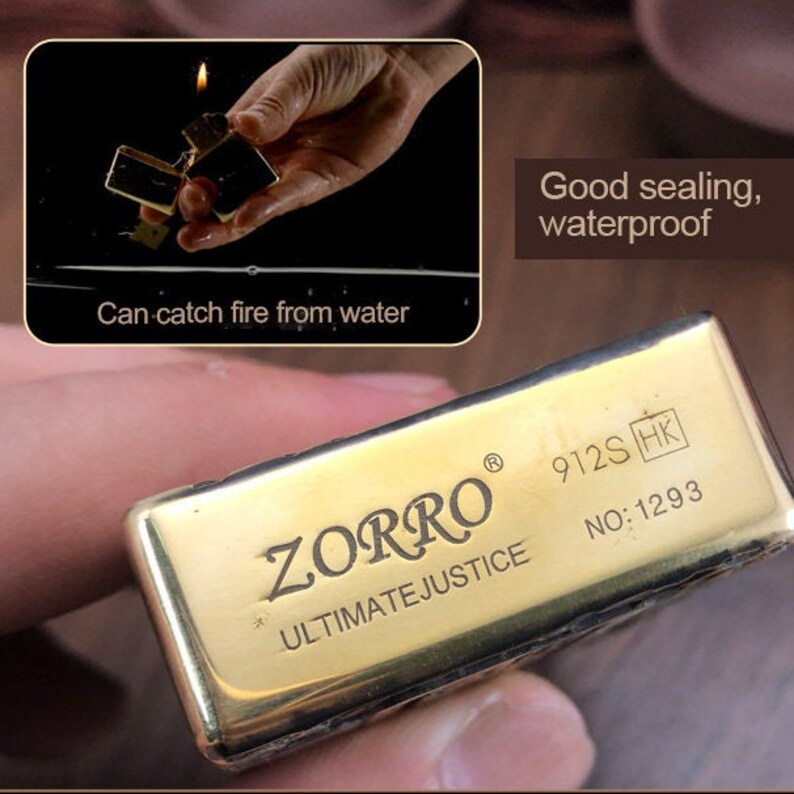 May include: A gold-colored ZORRO lighter with the text "ULTIMATEJUSTICE" and the number "1293" engraved on it. The image shows the lighter in use, with a flame visible. The text "Can catch fire from water" and "Good sealing, waterproof" are also present.