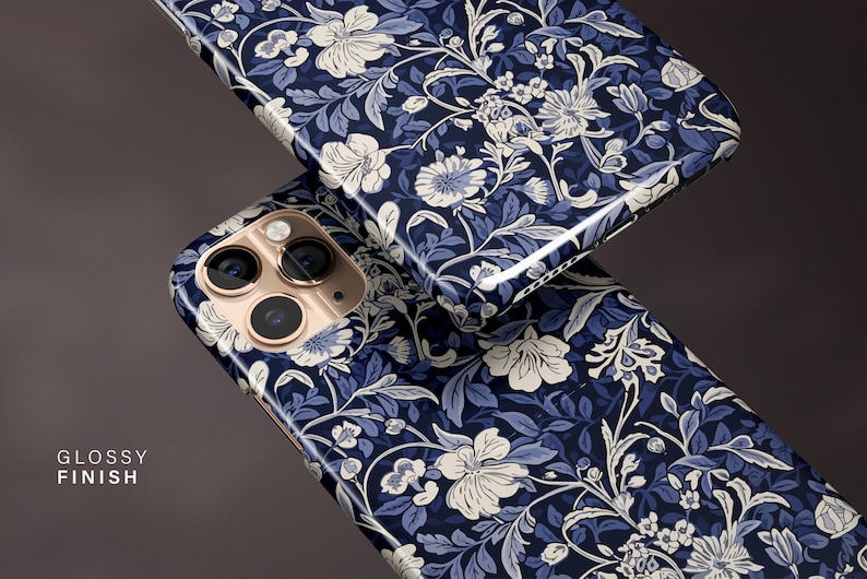May include: Two phone cases with a glossy finish, featuring a floral pattern in navy blue, light blue, and white. The cases have a detailed design of flowers and leaves. The text "GLOSSY FINISH" is visible on the left side of the image.