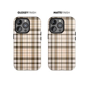 May include: Two phone cases with a plaid pattern in shades of brown, tan, and white. The case on the left has a glossy finish, and the case on the right has a matte finish. The text "GLOSSY FINISH" and "MATTE FINISH" are above each case.