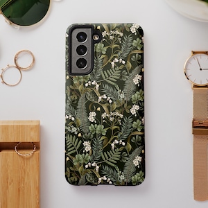 May include: A black phone case with a green floral pattern. The case has a cutout for the camera lens.