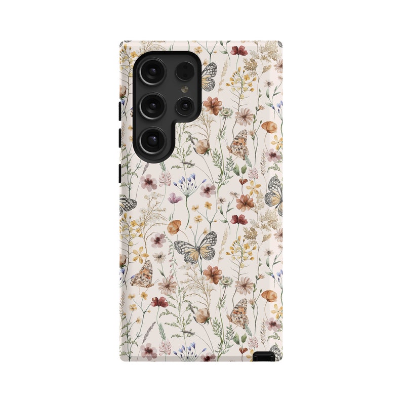 May include: A white phone case with a floral pattern featuring butterflies, flowers, and leaves in shades of brown, yellow, and pink.
