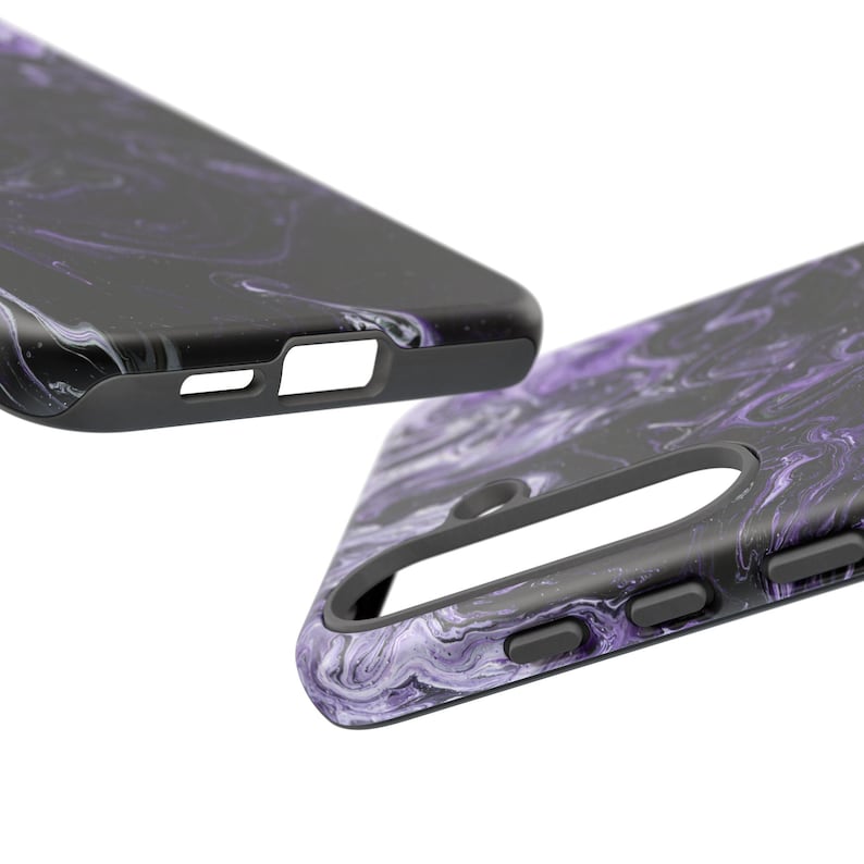 May include: Two black phone cases with a swirling purple and white marble design. The cases have a matte finish and feature cutouts for the camera, buttons, and charging port. The cases are shown at an angle against a white background.