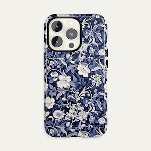 May include: A smartphone case featuring a floral pattern in shades of navy blue and white. The design includes stylized flowers, leaves, and vines, creating a classic, elegant look. The case has a glossy finish and a protective design.