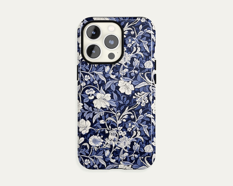 May include: A smartphone case featuring a floral pattern in shades of navy blue and white. The design includes stylized flowers, leaves, and vines, creating a classic, elegant look. The case has a glossy finish and a protective design.
