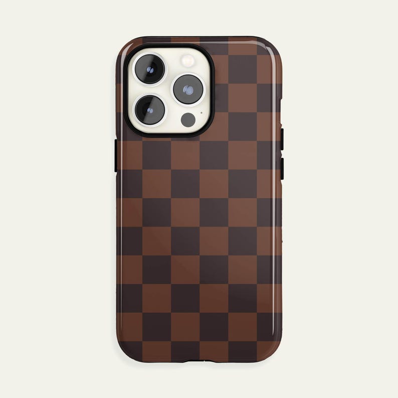 May include: A brown and dark brown checkered phone case. The case has a glossy finish and is designed to fit a smartphone. The camera lenses are visible at the top of the case.