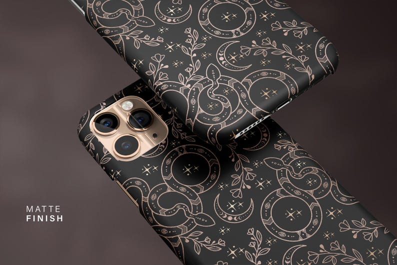 May include: Black phone cases with a matte finish, featuring a repeating pattern of snakes, crescent moons, stars, and floral elements in a rose gold color. The text "MATTE FINISH" is visible.