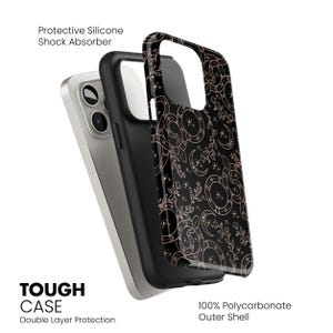 May include: Black phone case with a rose gold celestial pattern. The case is made of a protective silicone shock absorber and a 100% polycarbonate outer shell. The text "TOUGH CASE" and "Double Layer Protection" are visible.