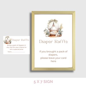 May include: A framed sign with the text "Diaper Raffle" and an illustration of a baby crib. The sign also includes instructions for a diaper raffle. A smaller card with the same design is also present.