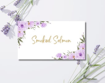 May include: A white rectangular card with the words "Smoked Salmon" in gold script. The card is decorated with watercolor-style purple flowers and green leaves. Lavender sprigs frame the card.