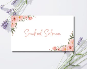 May include: A white rectangular card with the words "Smoked Salmon" in a soft pink script. The card is decorated with watercolor-style pink flowers and green leaves in the corners. Lavender sprigs frame the card.