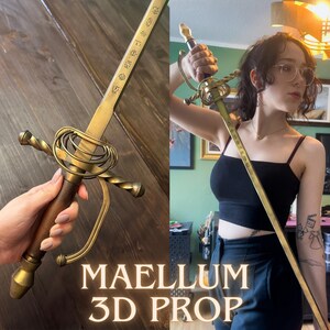 May include: A prop sword with a gold-colored blade and handle, featuring intricate detailing. The handle is brown with a gold-colored guard. The text "MAELLUM 3D PROP" is visible at the bottom of the image. The sword is likely a replica or decorative item.