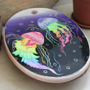 Acid jellyfish on wooden cutting board with black backgrounde, exclusive handmade kitchen board of decor