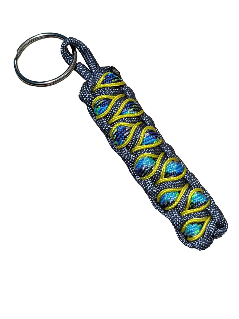 A keychain with a metal ring and a braided pattern in blue and yellow colors.