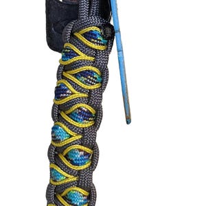 A multi-colored braided keychain with a blue and yellow pattern, hanging from a keyring.