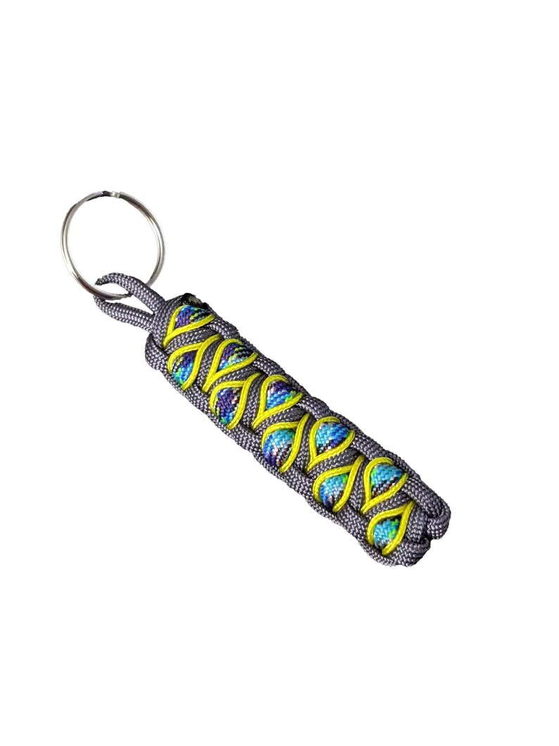 A gray and yellow braided keychain with a metal ring attached.