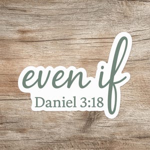 May include: A white sticker with the words "even if" in a script font and the text "Daniel 3:18" in a serif font. The text is in a muted green color. The sticker is on a wooden background.