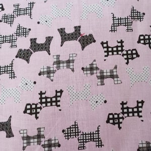 May include: Pink fabric with a repeating pattern of black and white Scottish terrier dogs. Some dogs have a plaid pattern, while others have a polka dot pattern.