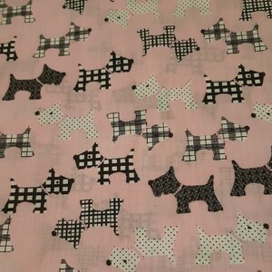 May include: Pink fabric with a repeating pattern of black and white Scottish terrier dogs. Some dogs are wearing a pink collar with white polka dots, while others are wearing a black and white plaid collar.