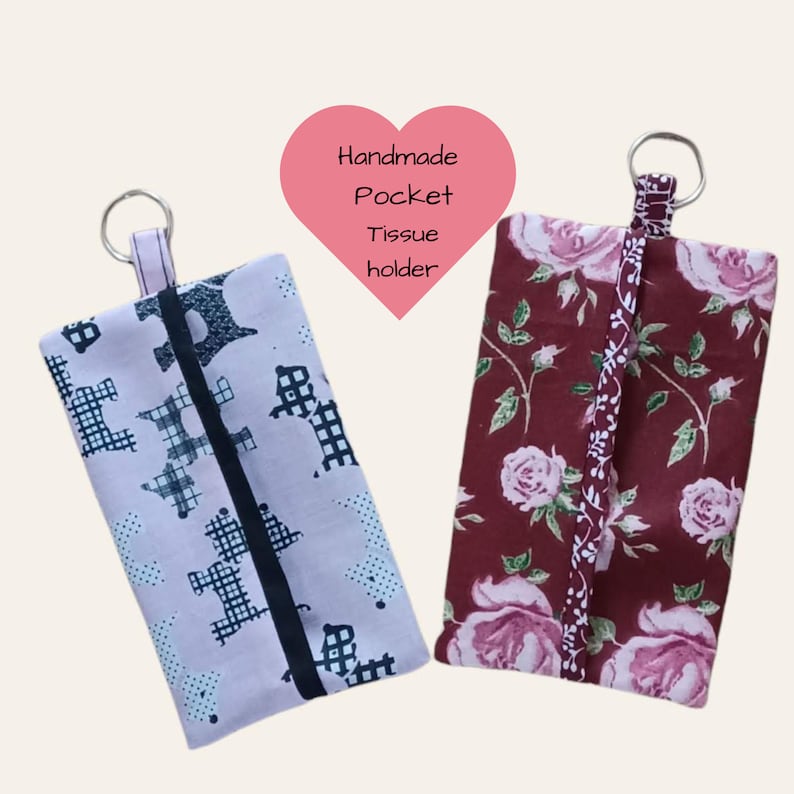 May include: Two handmade pocket tissue holders with key rings. One is pink with a black and white geometric pattern and the other is burgundy with a floral pattern.