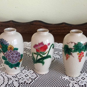 3 Homco 4" porcelain bud vases adorned with flowers and trimmed in gold. Made in Japan in the 1970's