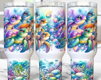 May include: A white stainless steel tumbler with a colorful illustration of sea turtles swimming in a blue and purple watercolor background with bubbles. The tumbler has a lid and a straw.