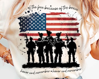 May include: A white t-shirt with a graphic print of an American flag and silhouettes of soldiers. The text "of the free because of the brave" and "honor and remember" is printed on the shirt.