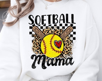 May include: White sweatshirt with a black and white checkered background, a leopard print, and a yellow softball with a red heart. The text "Softball Mama" is printed in black.