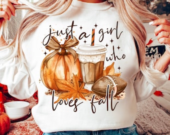 May include: White sweatshirt with the text "Just a girl who loves fall" in brown lettering. The design includes a pumpkin, a cup of coffee, and a football.