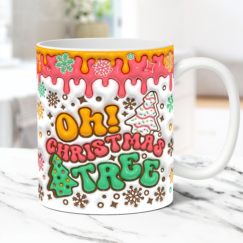May include: White ceramic mug with a colorful design featuring the words "Oh! Christmas Tree" in a dripping icing style. The design includes snowflakes, stars, and gingerbread trees.
