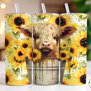 May include: A white tumbler with a design of a Highland cow with sunflowers and dripping honey. The tumbler has a black lid and a straw.