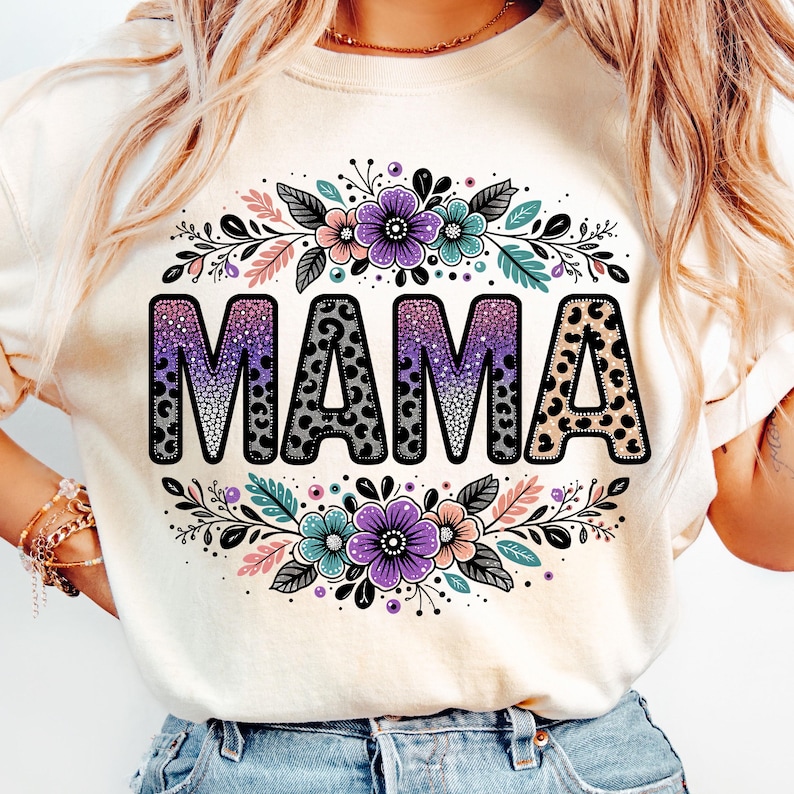 May include: A white t-shirt featuring a floral design and the word "MAMA" in black with a leopard print pattern.