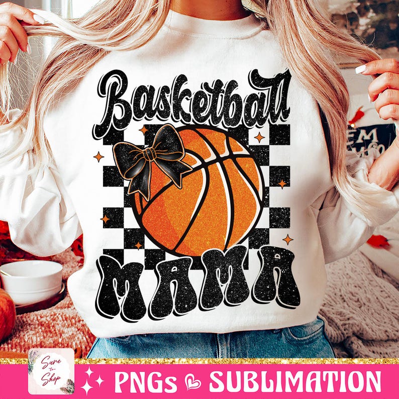 May include: White sweatshirt with a black and white checkered background, a basketball with a black bow, and the text "Basketball Mama" in black glitter letters.