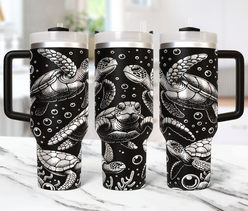May include: Three stainless steel tumblers with black lids and handles. The tumblers are decorated with a black and white pattern of sea turtles and bubbles.