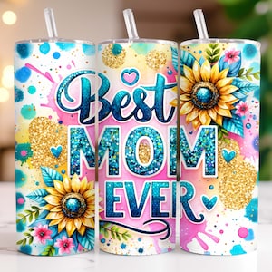 May include: A pink, blue, and yellow tumbler with a glitter design and the text "Best Mom Ever". The tumbler has a straw and is decorated with sunflowers and other floral elements.