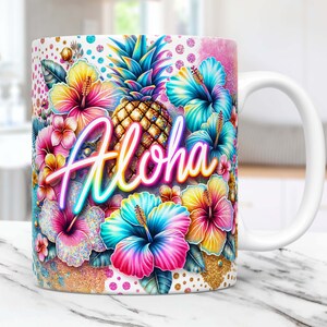 May include: White ceramic mug with a colorful design featuring a pineapple, hibiscus flowers, and the word "Aloha" in neon lettering. The background is a white and gold glitter pattern.