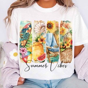 May include: White t-shirt with a colorful graphic design featuring a surfboard, seashells, sunflowers, a beach chair, and a picnic basket. The text "Summer Vibes" is printed below the graphic.