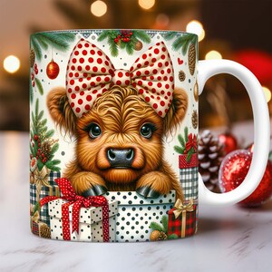 May include: White ceramic mug with a festive design featuring a brown and white Highland cow wearing a red and white polka dot bow. The cow is surrounded by Christmas-themed decorations, including presents, pine branches, and ornaments.