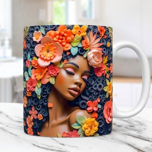 May include: White ceramic mug with a colorful illustration of a woman with closed eyes surrounded by orange, pink, and yellow flowers. The woman's hair is styled in a curly afro.
