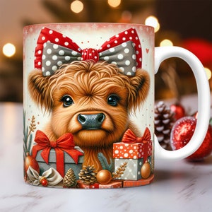 May include: A white ceramic mug with a festive design featuring a Highland cow wearing a red and white polka dot bow. The cow is surrounded by presents, pine cones, and ornaments.