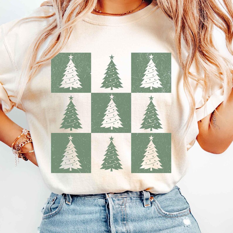 May include: A white t-shirt with a green and white checkered pattern featuring a repeating design of stylized Christmas trees.