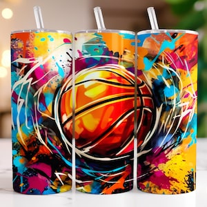 May include: Three colorful stainless steel tumblers with a basketball graphic and abstract paint splatter design. The tumblers are 20 oz and have a straw.