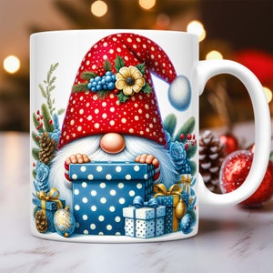 May include: A white ceramic mug with a Christmas gnome design. The gnome is wearing a red and white polka dot hat with a white pom-pom. The gnome is holding a blue and white polka dot gift box. There are other gift boxes around the gnome.